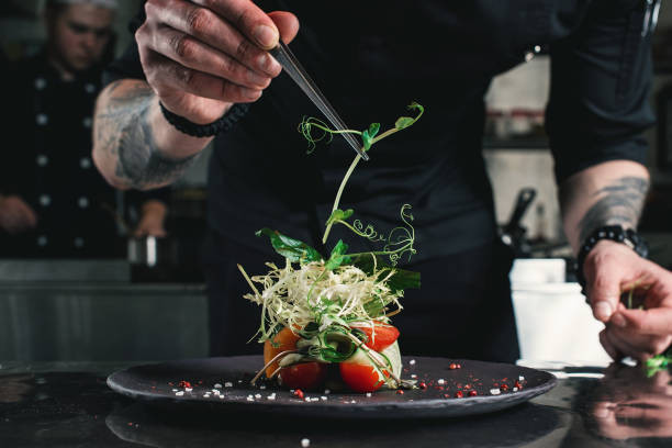 A chef expertly prepares fresh seafood in a bustling restaurant kitchen, highlighting the quality and freshness found in dining experiences, relevant to lifestyle content on Sowix Online.